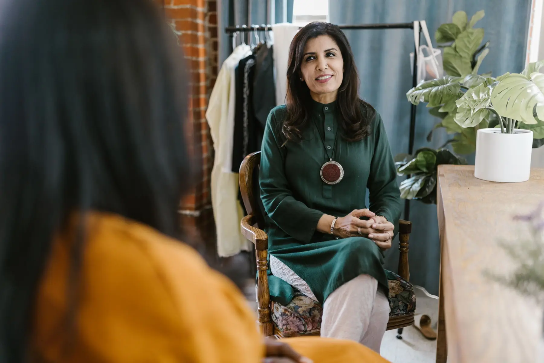 A woman speaking confidently during a conversation in a bright studio